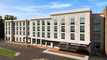 Experience the Hampton Inn HOME SUITES BY HILTON's sleek, contemporary design, featuring large windows and a welcoming atmosphere.