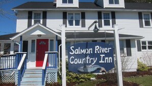 Un bâtiment à deux étages portant une enseigne indiquant « Salmon River Country Inn ».