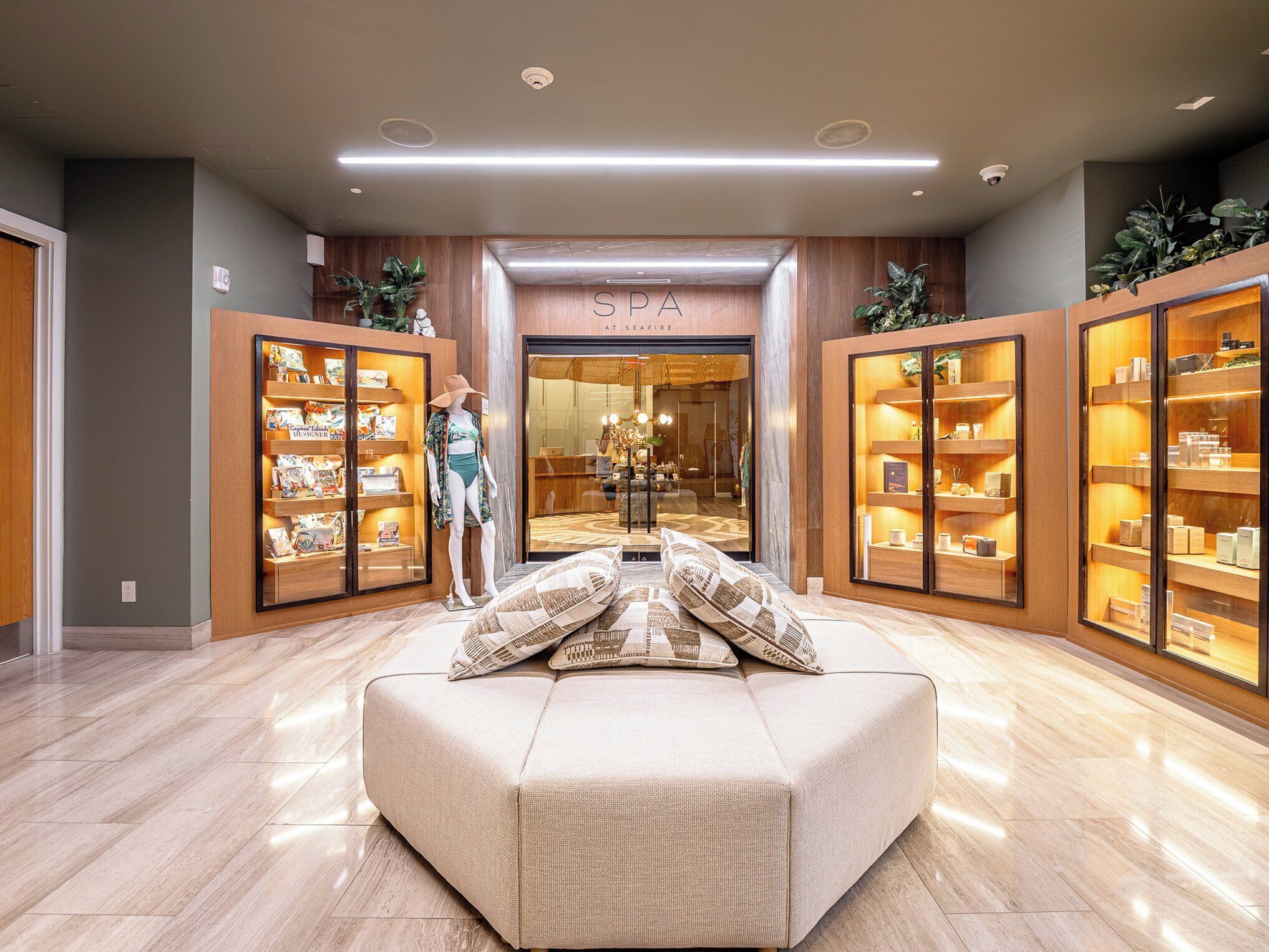 A spa with a reception area, a mannequin, and shelves with spa products.