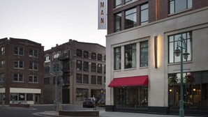 A multi-story hotel with a prominent vertical sign reading "THE JOURNEYMAN." - Kimpton Journeyman Hotel by IHG (Milwaukee)