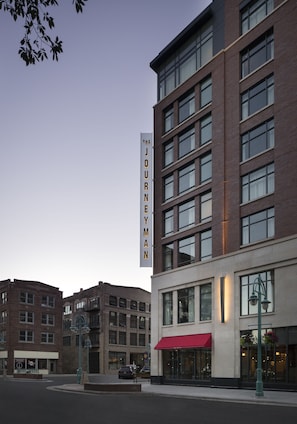 A multi-story hotel with a prominent vertical sign reading "THE JOURNEYMAN." - Kimpton Journeyman Hotel by IHG (Milwaukee)