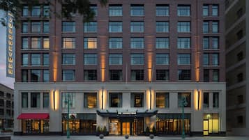 A multi-story hotel with a prominent entrance and a sign reading 'The Journeyman.'