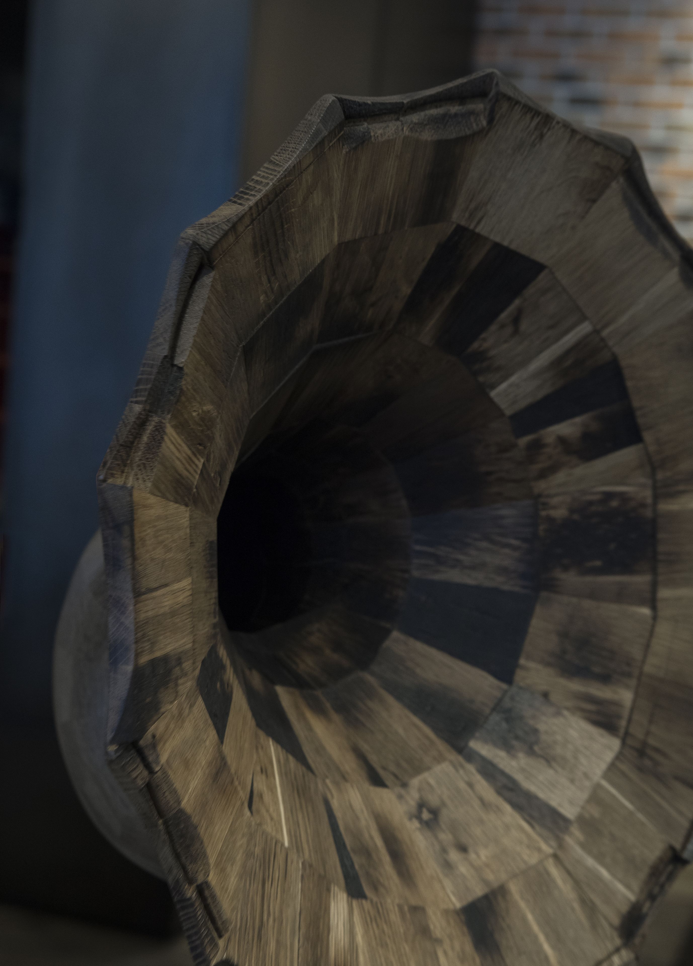 A wooden object with a spiral design, possibly a decorative piece or furniture.