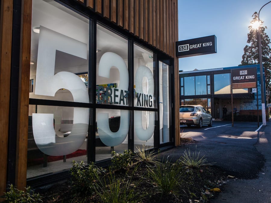 A building with large glass windows displaying the number 538 and the name "GREAT KING".