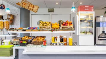 A buffet area with various food items and beverages.