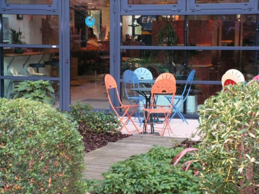 A patio area with outdoor seating and potted plants.