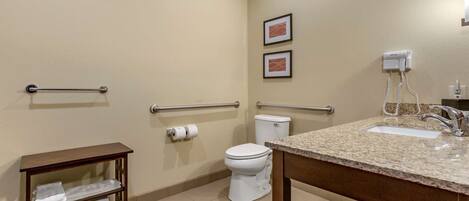 A bathroom with a sink, toilet, towel rack, and hand dryer.