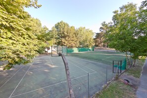 An outdoor tennis court surrounded by trees. - Olympios Zeus (Dio-Olympos)