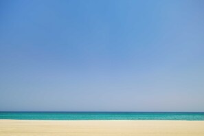 A beach with a clear sky and calm sea. - Olympios Zeus (Dio-Olympos)