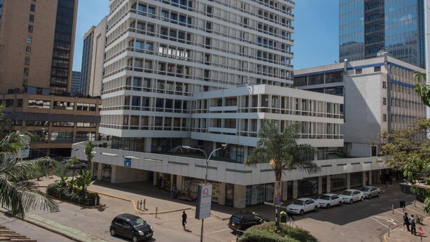 Un edificio de varios pisos con un diseño arquitectónico moderno, que presenta una fachada tipo entramado y grandes ventanales.