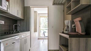 Una cuina moderna amb rentaplats, microones i cafetera.