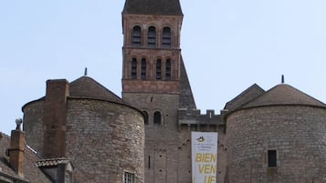 A historic building with a prominent tower and a banner advertising a cycling tour.