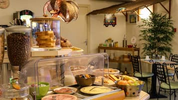 A buffet with various food items, including pastries, fruits, and a variety of dishes.