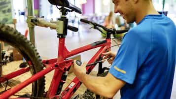 A person adjusting a bicycle's gear mechanism.