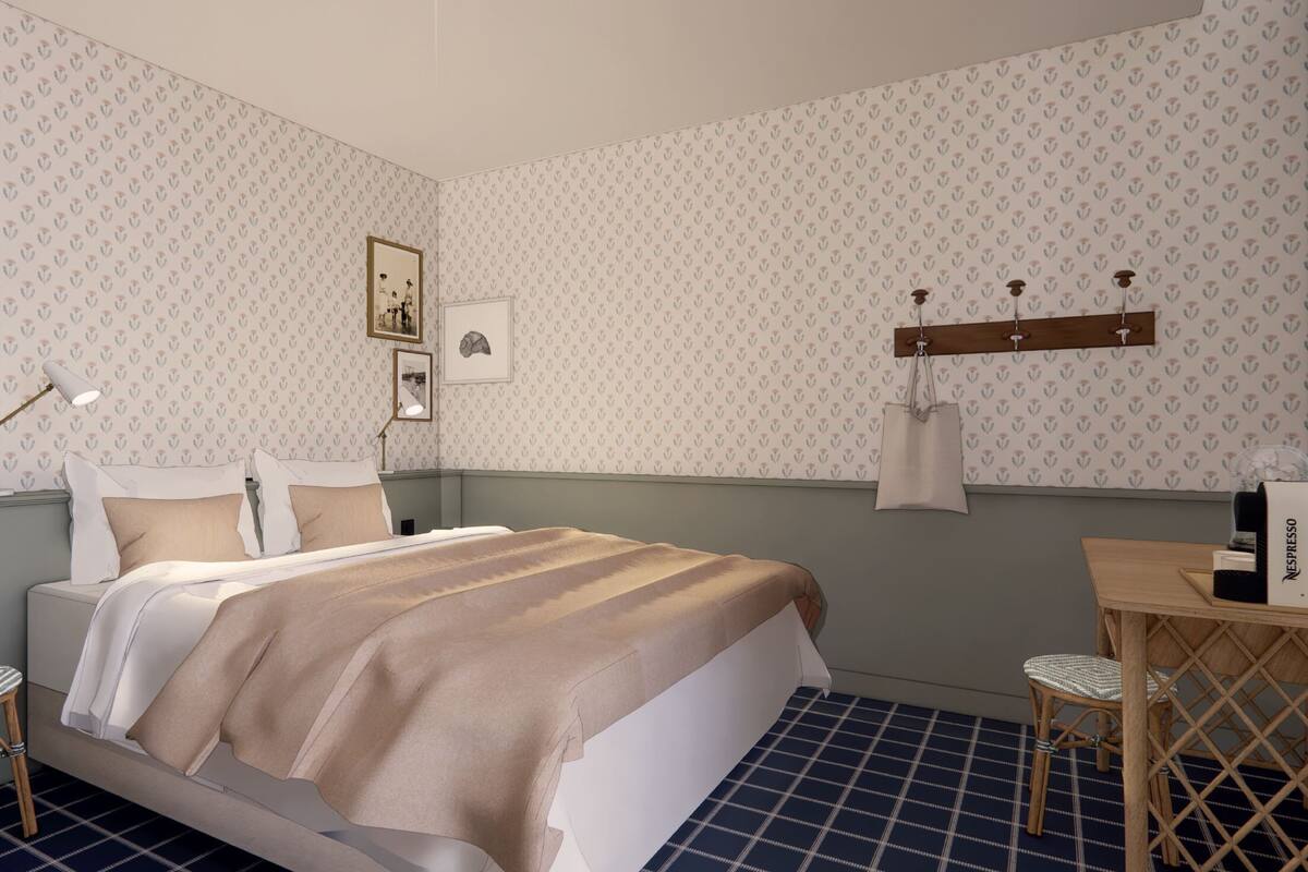 A neatly arranged bedroom with a bed, bedside tables, a desk, and a chair.