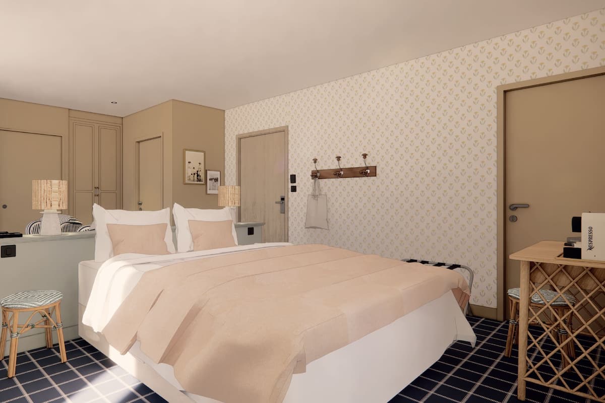 A hotel room with a large bed, bedside tables, a mirror, and a wardrobe.