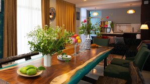 A dining area with a wooden table, chairs, and a vase with flowers. - Nagawari Art Maldives BBQ Pattaya Villa (Sattahip)