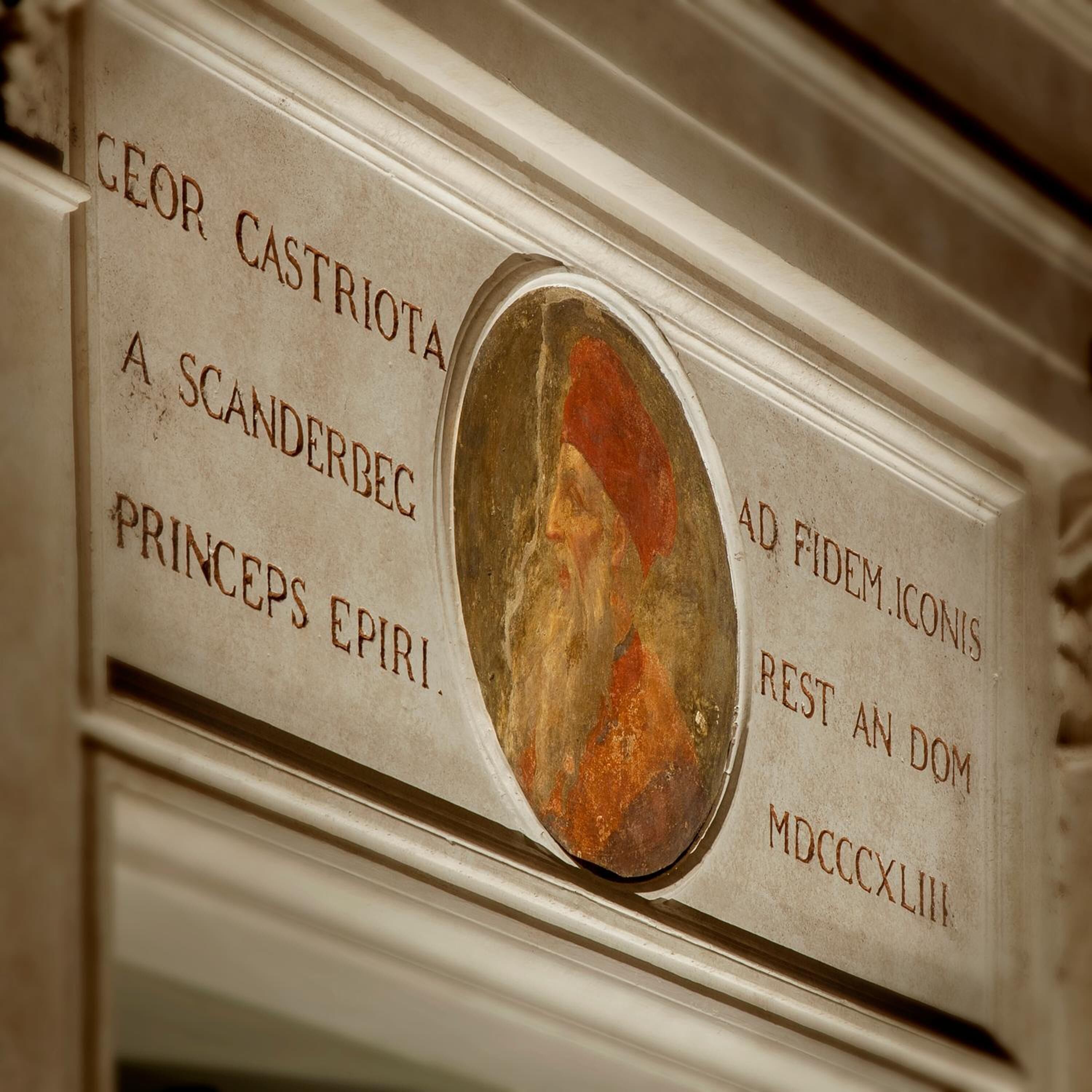 A plaque with inscriptions and a circular emblem.