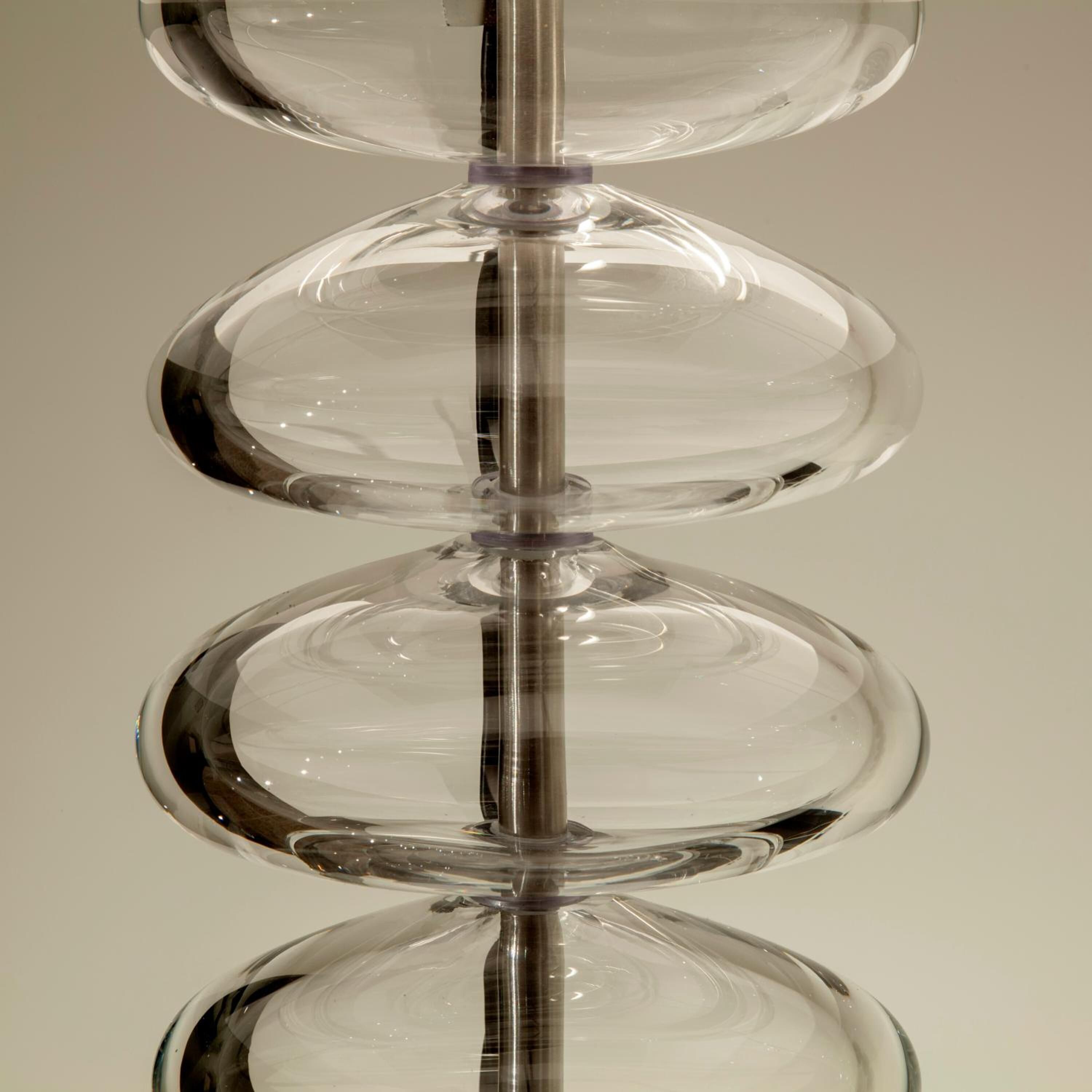 A clear glass sculpture with multiple layers.