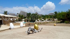 A resort with a sandy beach, palm trees, and a pool area. - Kola Beach Resort (Malindi)