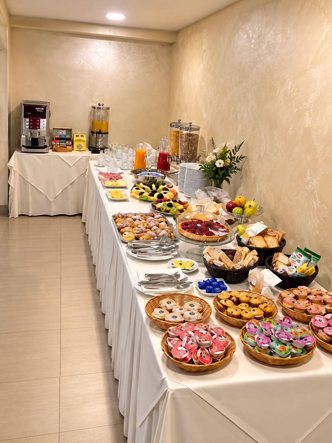 A buffet setup with various food items and beverages.