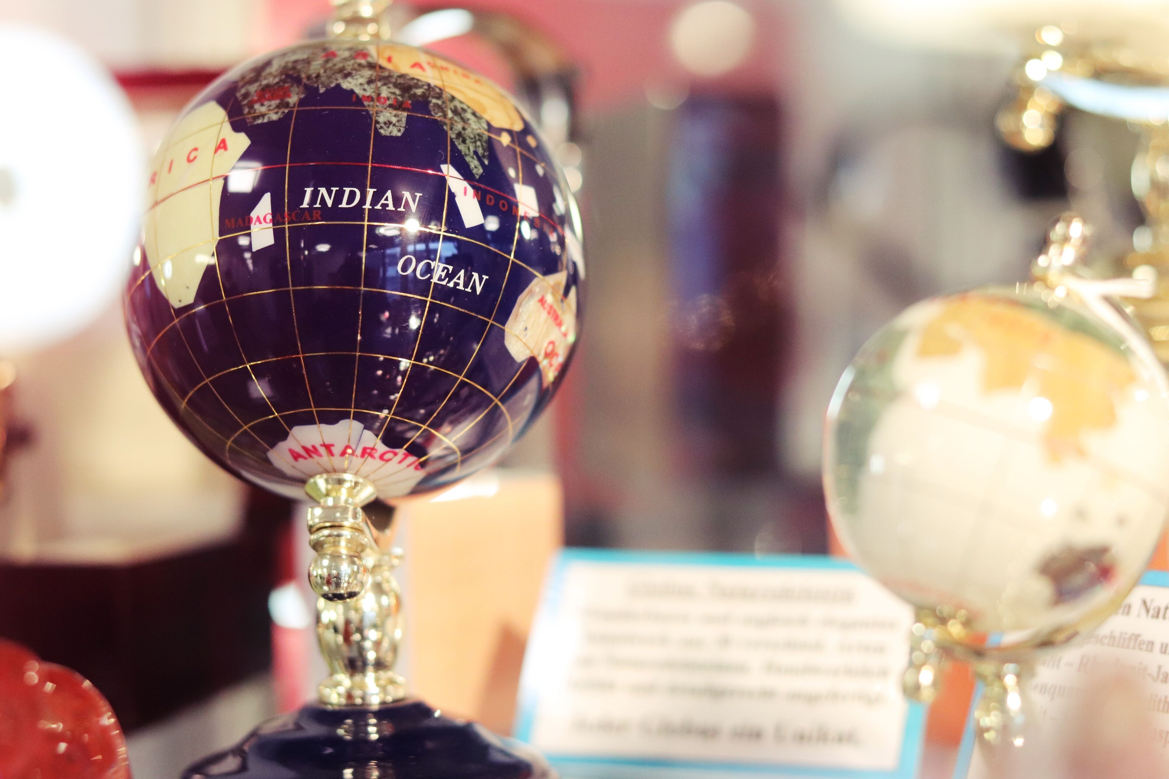 A globe with the label "Indian Ocean" and a sign with text in a foreign language.
