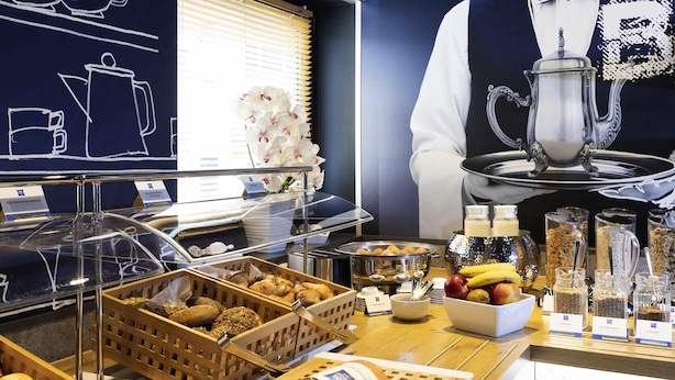 A breakfast buffet with various food items and a coffee station. - ibis budget Ludwigsburg (Ludwigsburg)