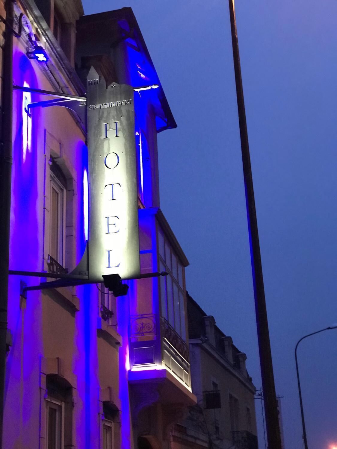 A hotel sign with the name "HOTEL" in capital letters, mounted on a building facade.