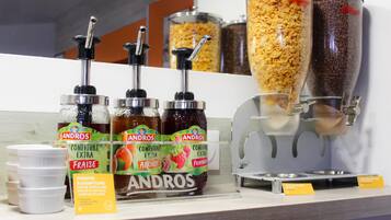 A self-serve condiment station with Andros brand sauces and a coffee dispenser.