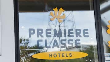 A window with the text "PREMIERE CLASSE HOTELS" and a maple leaf logo.