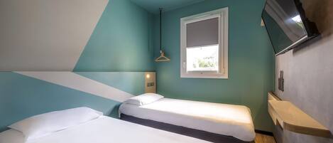 Un dormitorio moderno con dos camas, una ventana, un televisor y una lámpara colgante.