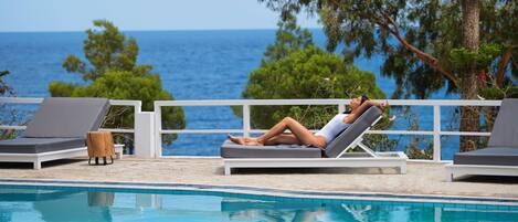 Piscine extérieure en saison, parasols, chaises longues