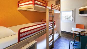 A bunk bed room with a desk and chair, a window, and a wall-mounted air conditioner.