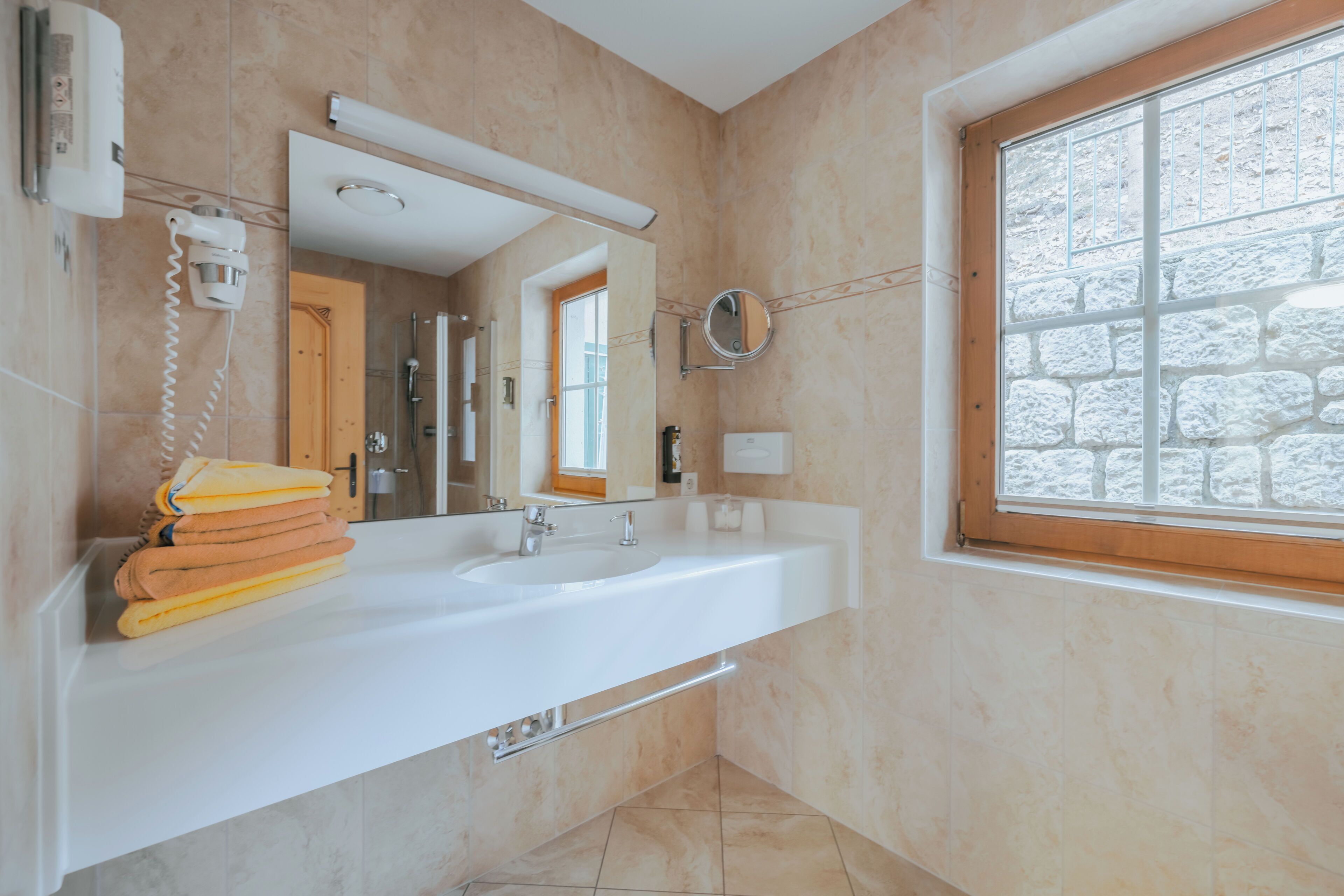 comfort suite (zillertal) | bathroom | eco-friendly toiletries, hair dryer, bathrobes, slippers