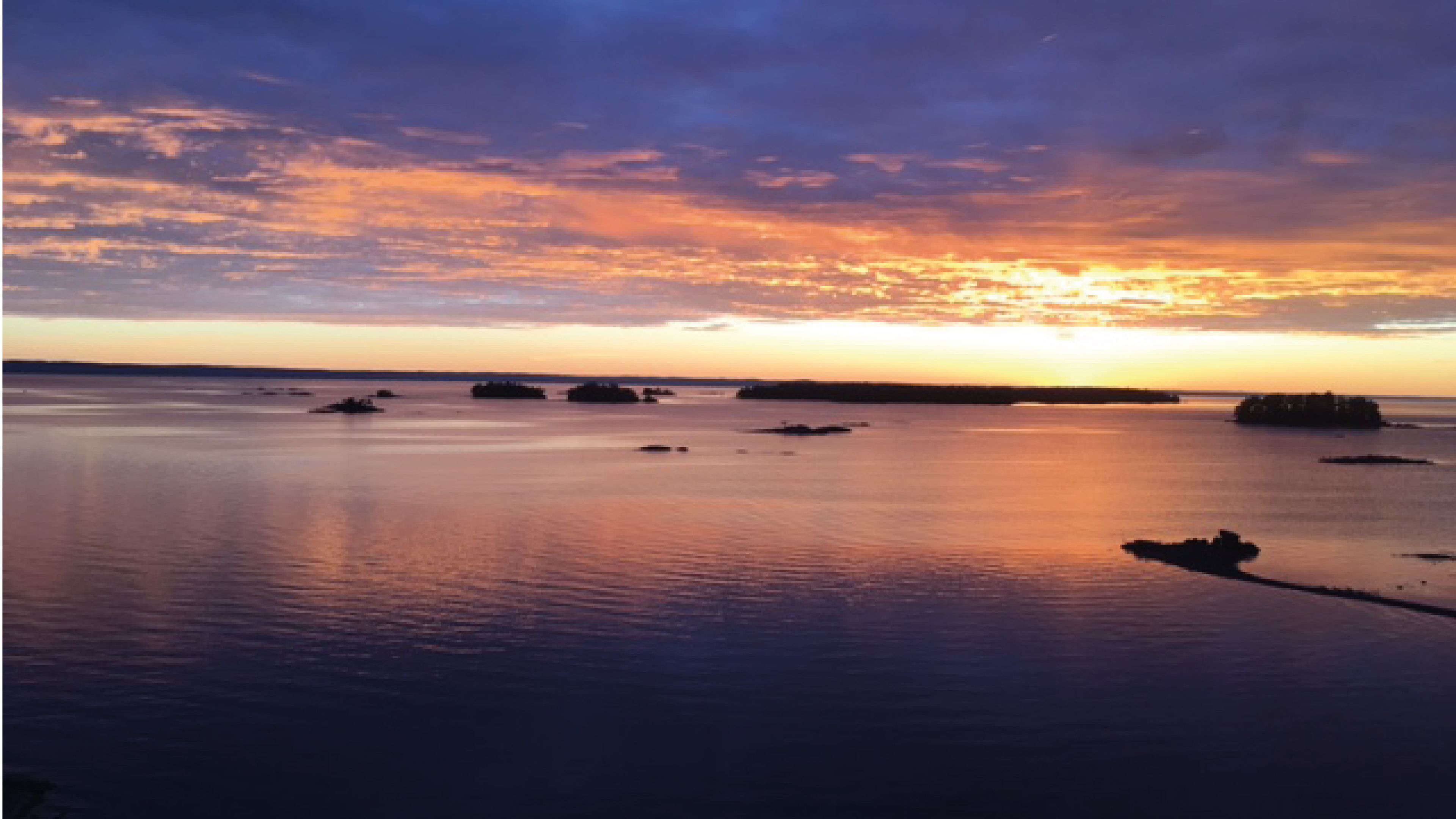A calm body of water with several small islands or landmasses.