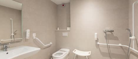 A modern bathroom with a sink, toilet, and shower.