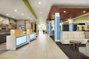 A hotel lobby with a reception desk, seating area, and a view of the hallway. - Holiday Inn Express & Suites Salisbury by IHG (Salisbury)
