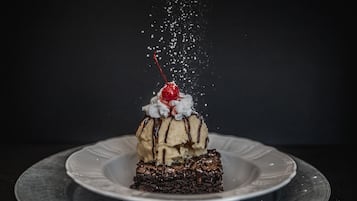 A dessert on a plate with a dark background.