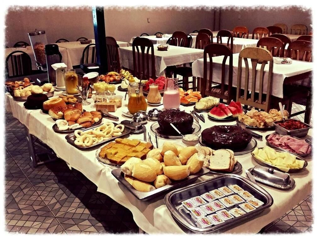 Uma mesa de buffet com diversos alimentos e bebidas.