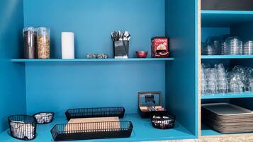 A blue-themed room with shelves holding various items like containers, a box labeled 'Professional', and a framed picture.