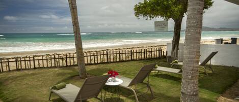 On the beach, white sand, sun loungers, beach towels