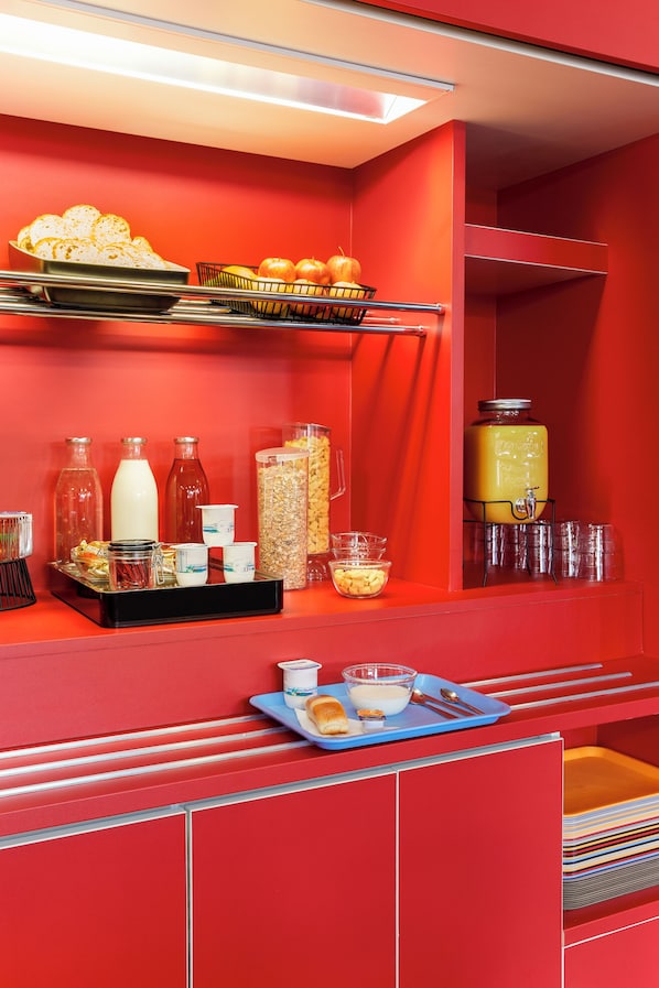 A red buffet setup with various food items, beverages, and condiments. - hotelF1 Lille Métropole (Métro Mons Sarts) (Mons-en-Baroeul)