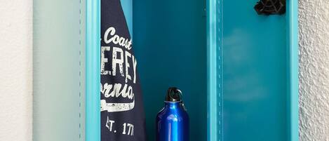A blue metal locker with a water bottle inside.