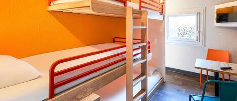 A bunk bed room with a desk and chair, a window, and a wall-mounted air conditioner.