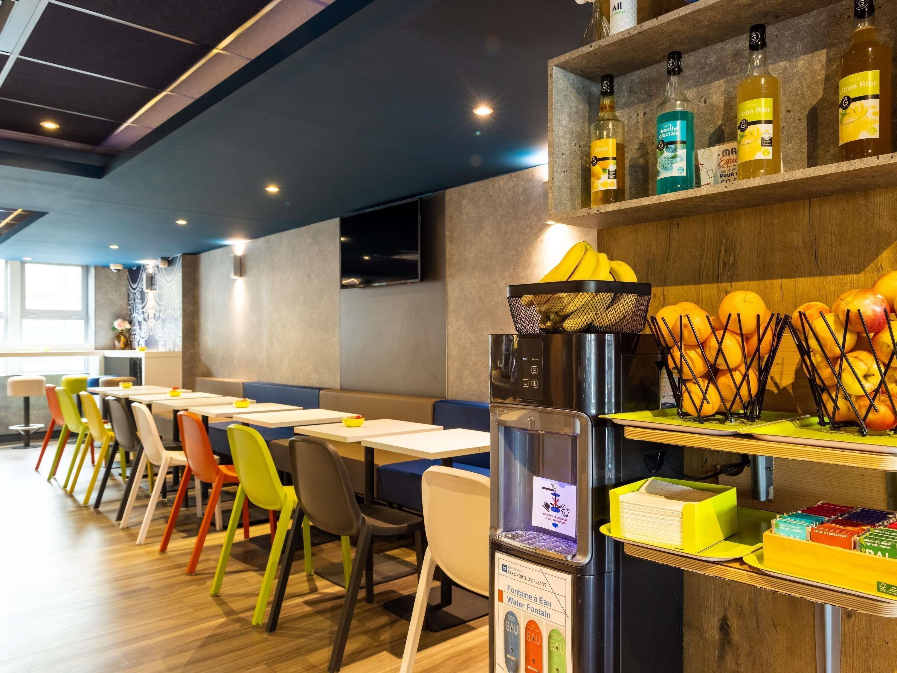 A restaurant interior with a water fountain, seating area, and a display of beverages.