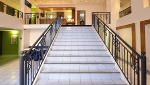 A staircase with black railings and white steps leading to a second floor. - ibis budget Nice Aeroport Promenade des Anglais (Nice)