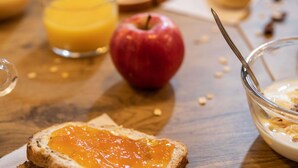 A breakfast setting with toast, apple, orange juice, and a bowl of cereal. - hotelF1 Paris Saint-Denis Université (Saint-Denis)