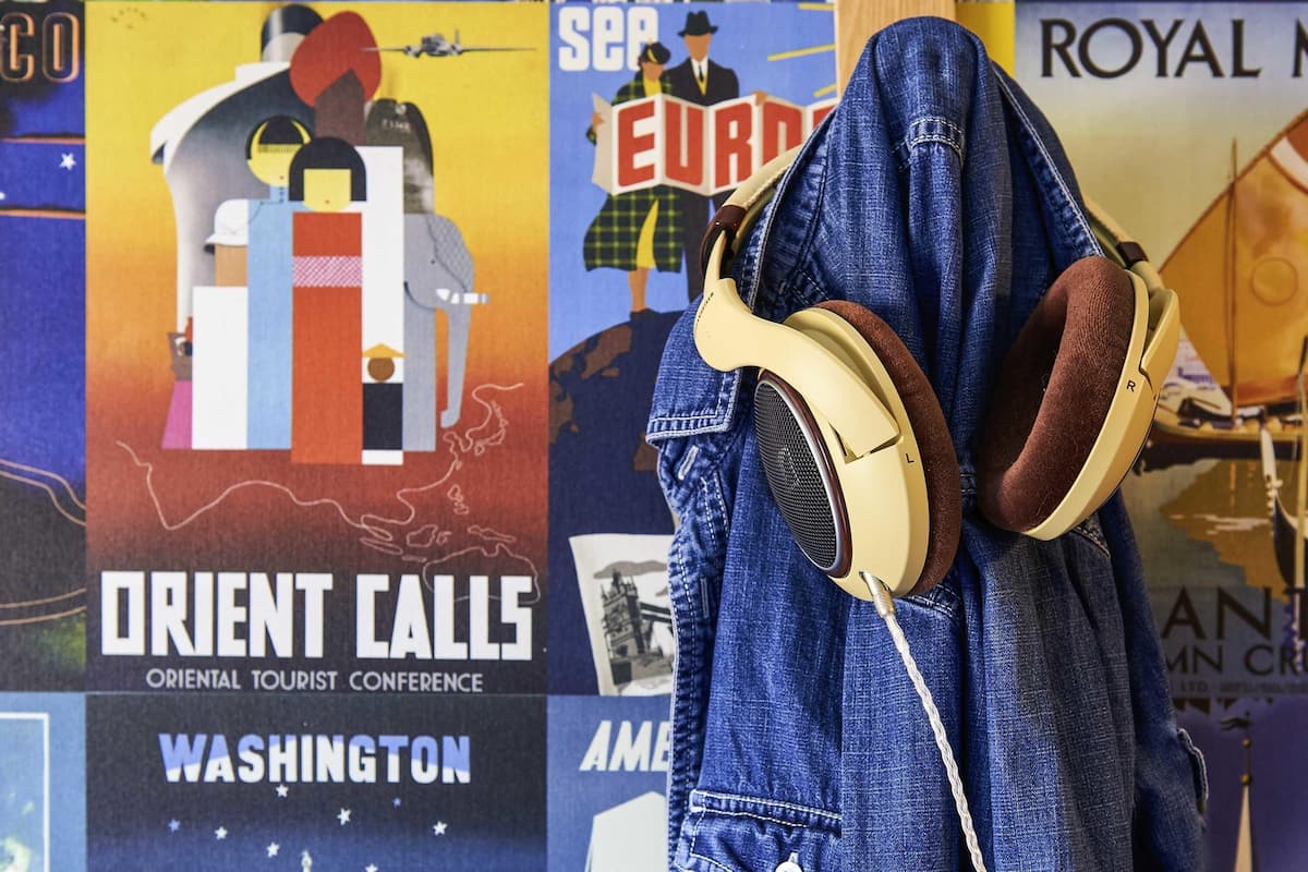 A poster with 'Orient Calls' and 'Oriental Tourist Conference' text, a person wearing a denim jacket, and a pair of headphones.