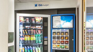 A vending machine with a variety of snacks and drinks, including a selection of bottled water and sodas. - ibis budget Sucy en Brie (Sucy-en-Brie)