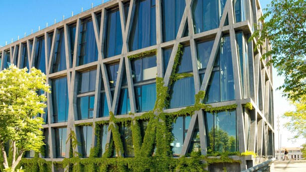A modern building with a grid-like facade, large windows, and some greenery growing on the exterior. - hotelF1 Aix en Provence Sainte Victoire Hotel (Meyreuil)